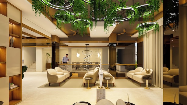 Un vestíbulo moderno con una recepción, zona de estar y plantas colgantes.