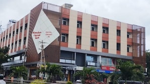 Un hotel de varios pisos con un letrero llamativo que indica que es un 'HOTEL GRAND IN'.