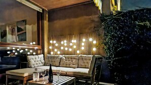 A modern living room with a sofa, coffee table, and decorative lights.