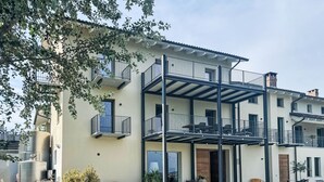 A multi-story building with balconies, outdoor seating, and a water tank. - Tenuta Bricco San Giorgio by Interhome (Vinchio)