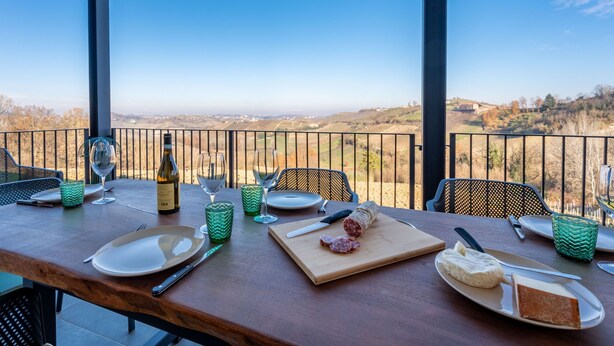 A dining table set outdoors with a scenic view. - Tenuta Bricco San Giorgio by Interhome (Vinchio)