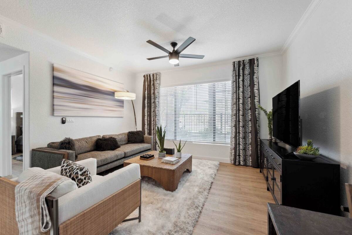A modern living room with a sofa, coffee table, and TV.