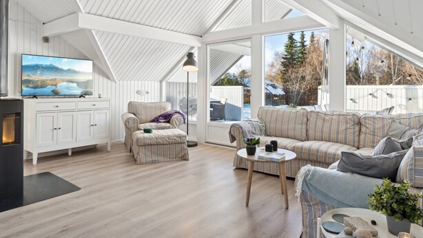 A spacious living room with a high ceiling, large windows, and a fireplace. - "Janik" - 1.3km from the sea by Interhome (Græsted)