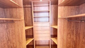 A walk-in closet with wooden shelving and drawers, featuring a herringbone-patterned floor. - Magnificent 158m² loft in Caluire le bas, 10mm from Lyon 6,  (Caluire-et-Cuire)