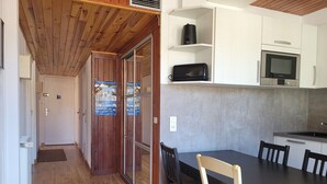 A compact kitchen with white cabinets, a Bosch microwave, and a Bosch oven.