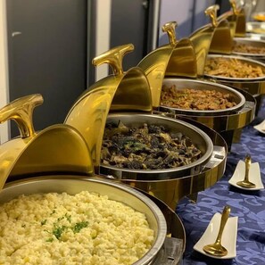 A buffet with various dishes in gold-rimmed serving dishes. - FANCO HOTEL  (Bamahu)