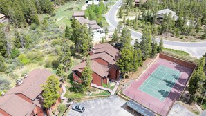 An aerial view of a residential area with houses, a tennis court, and a winding road. - 6 Mi to Skiing: Condo w/ Balcony in Fraser! (Fraser)