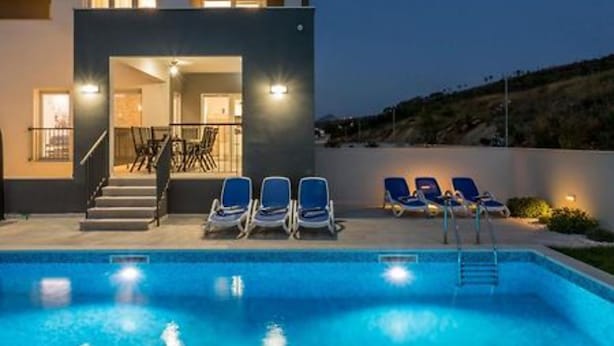 A modern building with a swimming pool, lounge chairs, and a staircase leading to an upper level. - Modern & Stylish Villa With Private Pool (Omis)