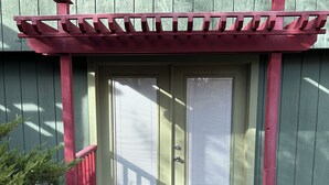 A green door with a red porch and a black doormat. - Spacious Home + private suite with separate entrance. Family friendly! (Prescott)