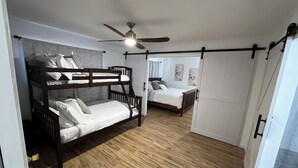 A room with a bunk bed, a single bed, a ceiling fan, and a wardrobe. - Spacious Home + private suite with separate entrance. Family friendly! (Prescott)