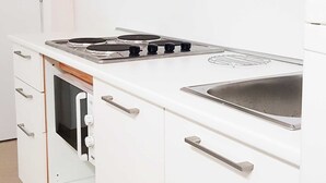 A kitchen with a stove, oven, and sink. - Seafront Chic Crikvenica Apartments (Crikvenica)