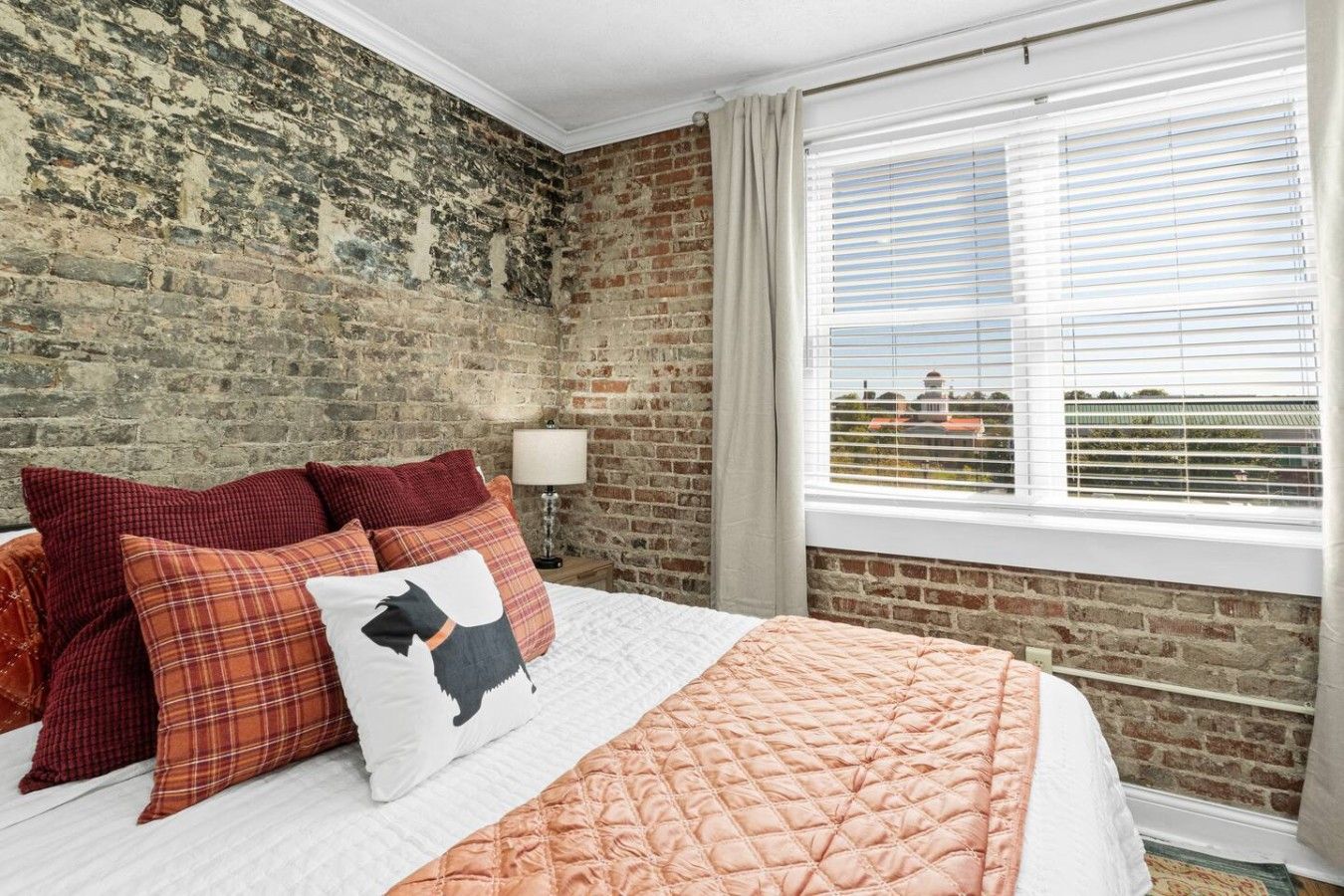 Wake up to stunning views of the Maryville College campus right from your king-size bed. The large window brings in plenty of natural light, while the exposed brick wall and warm décor create a cozy, inviting atmosphere in the heart of downtown Maryv