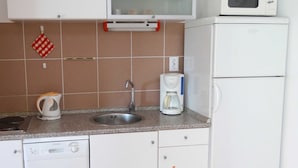 A kitchen with a sink, a coffee maker, a microwave, and a dishwasher. - Charming and Cozy Apartment Crikvenica (Crikvenica)