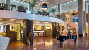 A spacious lobby with a grand piano, a reception desk, and a staircase leading to upper levels. - Pickalbatros Hôtel Du Golf - Adults Friendly 16 Years Plus- All-Inclusive (Marrakech)