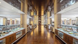 A buffet area with multiple serving stations, wooden flooring, and a central aisle. - Pickalbatros Hôtel Du Golf - Adults Friendly 16 Years Plus- All-Inclusive (Marrakech)