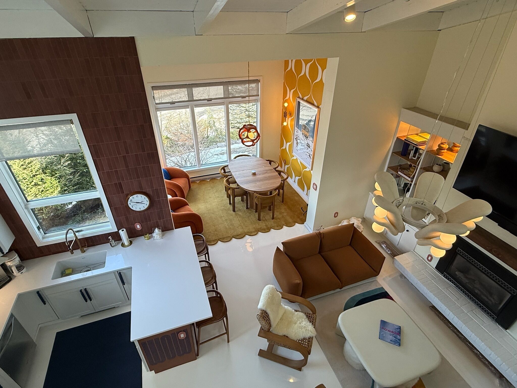 A modern living space with a kitchen, dining area, and seating area.