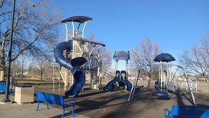 A playground with slides, swings, and benches. - Sunny Private Guest Suite, 30 min from Denver/Boulder, Kids and Pets welcome! (Broomfield)