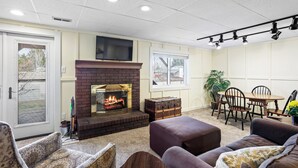 A living room with a fireplace, a dining area with a table and chairs, and a seating area with sofas. - Sunny Private Guest Suite, 30 min from Denver/Boulder, Kids and Pets welcome! (Broomfield)
