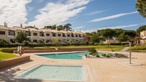 Un complexe hôtelier doté d’une piscine, d’une bouée de sauvetage et d’une pelouse bien entretenue.