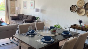 A dining area with a table set for four, surrounded by chairs. A ceiling fan is visible above the table. - Modern&Quiet full Apartment with Pool in Punta Sur, relax and enjoy this place (Isla Mujeres)