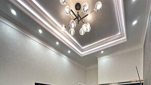 A modern bedroom with a large bed, a television, a mirror, and a wardrobe. - Tashkent city Bulevard 144 RNB estate (Tashkent)