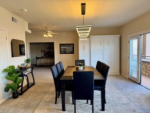 Enjoy meals in this dining area with a table for four, pendant light, and large window.