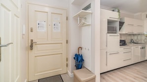 A modern kitchen with white cabinets, a built-in oven, and a microwave. - Piasek Apt - Top Location, Patio, Tram&Bus nearby - by Rentujemy (Kraków)