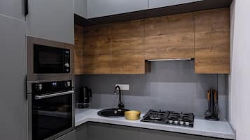 Family Condo, City View | Private kitchen | Stovetop, electric kettle