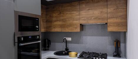 Family Condo, City View | Private kitchen | Stovetop, electric kettle