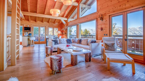 A spacious wooden cabin with a large living area, a dining table, and a cozy seating arrangement. - Nicande - EXCEPTIONAL & LUXE chalet 8 pers (Haute-Nendaz)