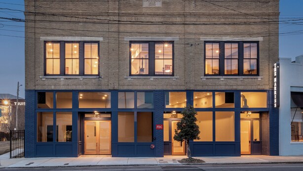 A two-story building with large windows and a sign reading "HARRIS 1916". - The Harriss (Wilson)