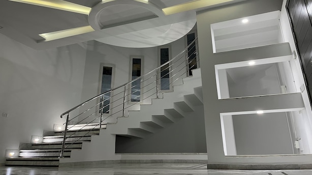 A modern interior with a central staircase, recessed lighting, and a minimalist design. - Villa The Crown  (Ariana)
