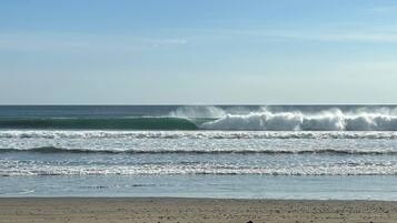 A beach with waves crashing onto the shore.