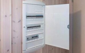 A white electrical panel with multiple circuit breakers and a door. - 5 Star Holiday Home in Vejers Strand (Vejers Strand)