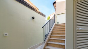 A staircase with beige walls and a metal railing leading to an upper floor. - Apartment With Scenic View (Porec)