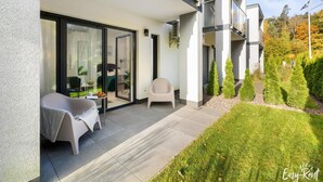 A modern apartment with a balcony, a dining area, and a small garden. - Studio in Niechorze Near Baltic Beach (Rewal)