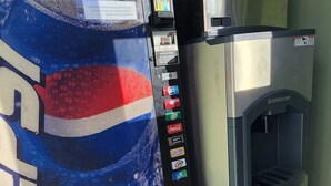 A vending machine with a Pepsi logo and a water dispenser next to it. - Plaza Motel (Joplin)