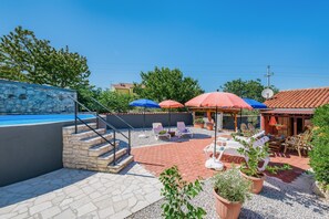 A patio area with outdoor seating, a pool, and a stone staircase. - Nice Apartment With Pool (Visnjan)