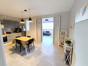 Apartment, Sea View | Private kitchen | Electric kettle, highchair, dining tables