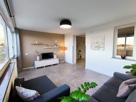 Apartment, Sea View | Living area | Flat-screen TV