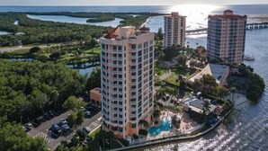 A high-rise hotel with a pool and waterfront views.