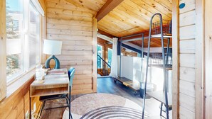 A wooden interior with a desk, chair, lamp, and a view of a staircase. - Mountain Serenity | Ski, Golf, Casino and Lake within 5 mile (Stateline)