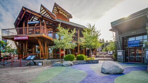 A multi-story wooden building with balconies, a sign for 'The North Face,' and a nearby entrance to 'Cologne Tahoe.' - Mountain Serenity | Ski, Golf, Casino and Lake within 5 mile (Stateline)