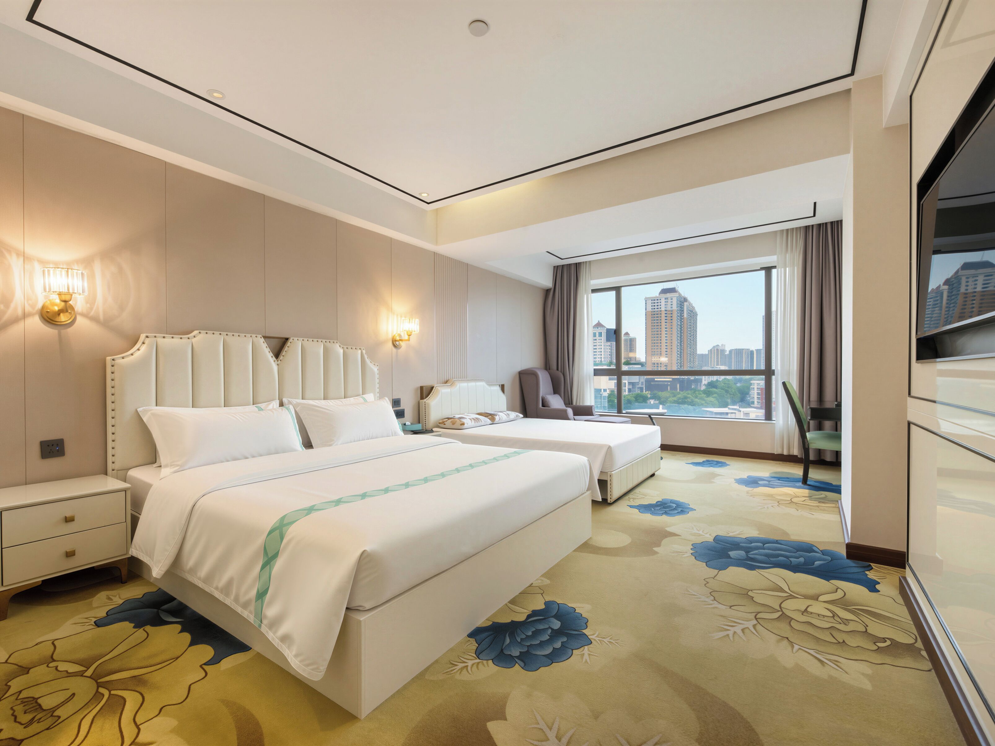 A hotel room with two beds, a large window with a city view, a chair, and a nightstand.