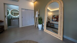 A modern interior with a large mirror, a ladder, and a potted plant. - Seminyak 3BR Private Pool Villa (Seminyak)