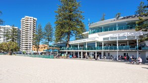 A beachfront building with a sign reading "Burleigh Heads Mowbray Park Buff Life Saving Club". - Waterfront Canal Escape in Burleigh (Burleigh Waters)