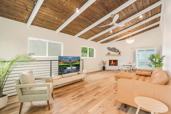 Enjoy bright living areas, high Ceilings, smart TVs and comfy leather couch