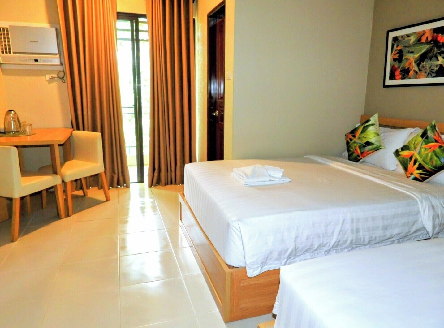 A hotel room with a bed, a desk, and a chair.