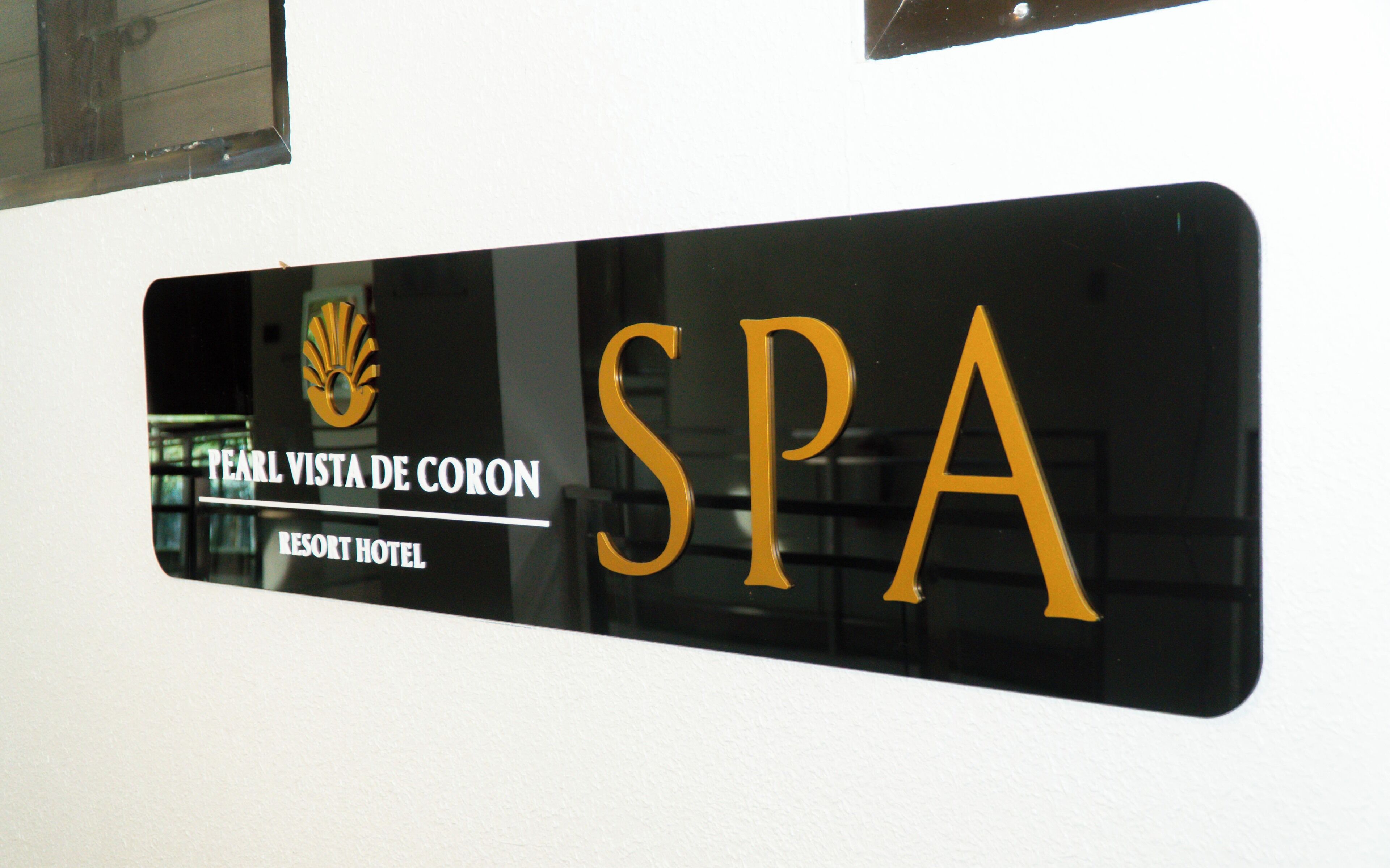 A sign for 'Pearl Vista de Coron Resort Hotel' indicating a spa facility.