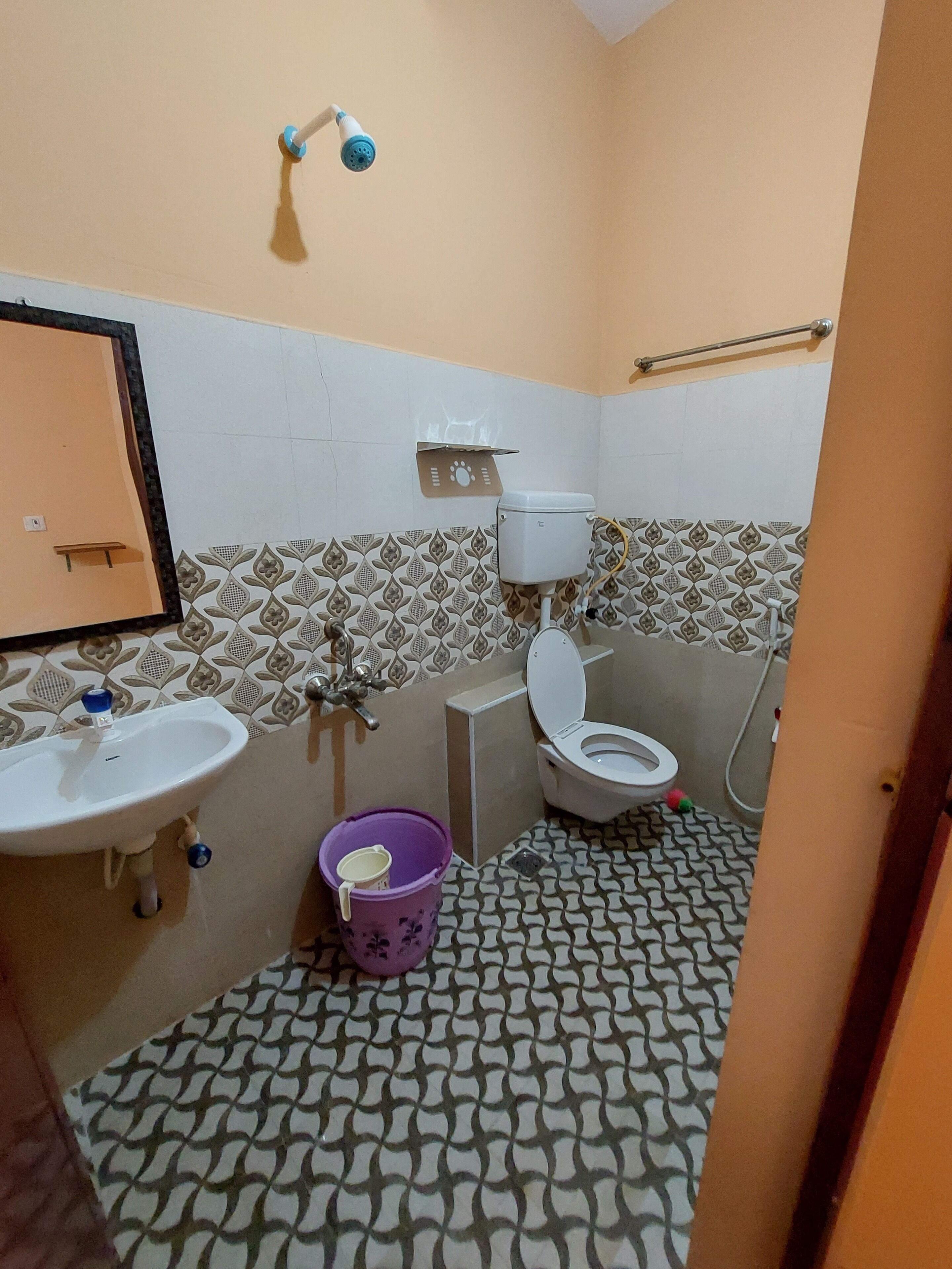 A small bathroom with a sink, toilet, and shower.